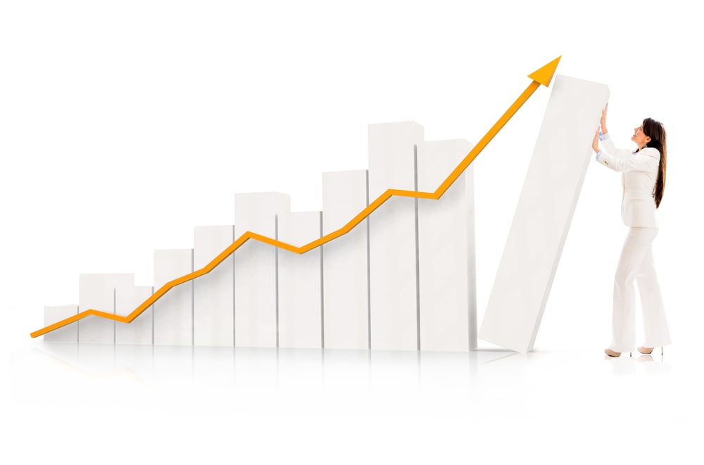 Business woman pushing a growing graph - isolated over a white background